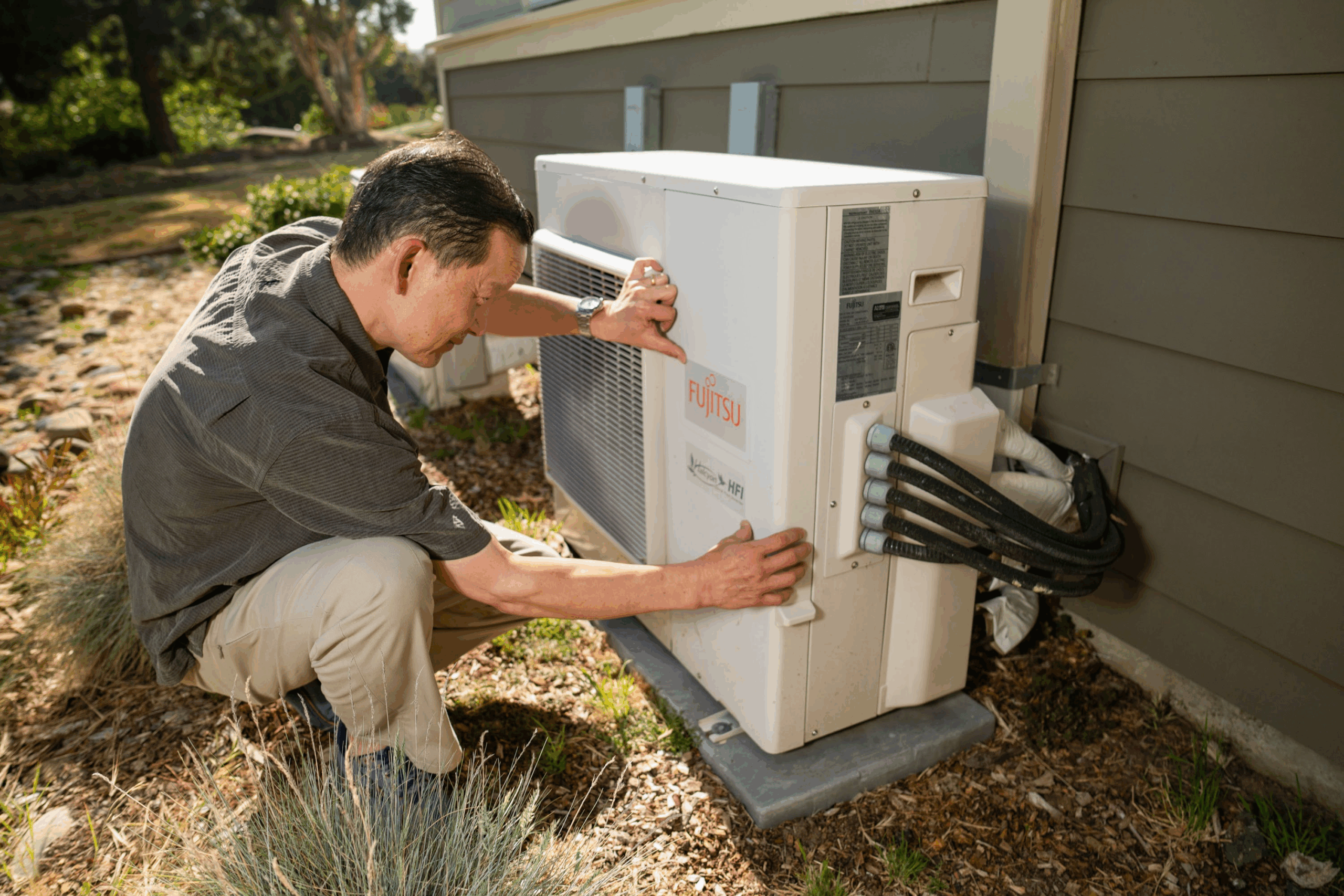 Photo of a contractor installing a Fujitsu heat pump.